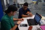 two males interacting while sitting at a desk at tutoring center