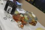 small ceramic elephants next to Indian food in glass dish