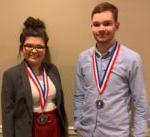 male and female looking at camera both wearing a medal