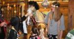 student and horse dressed in disco costumes with kids in costume petting the horse